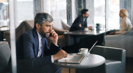 Manager on a call reviewing a laptop