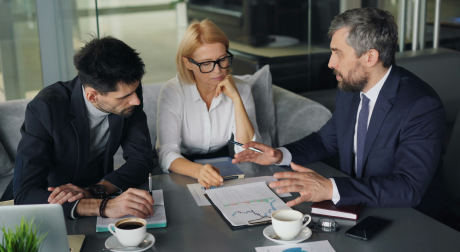 Leadership team reviewing reports in a meeting